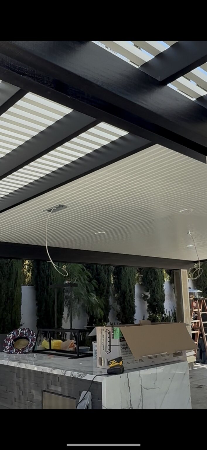 White ceiling patio cover with integrated electrical preparation
